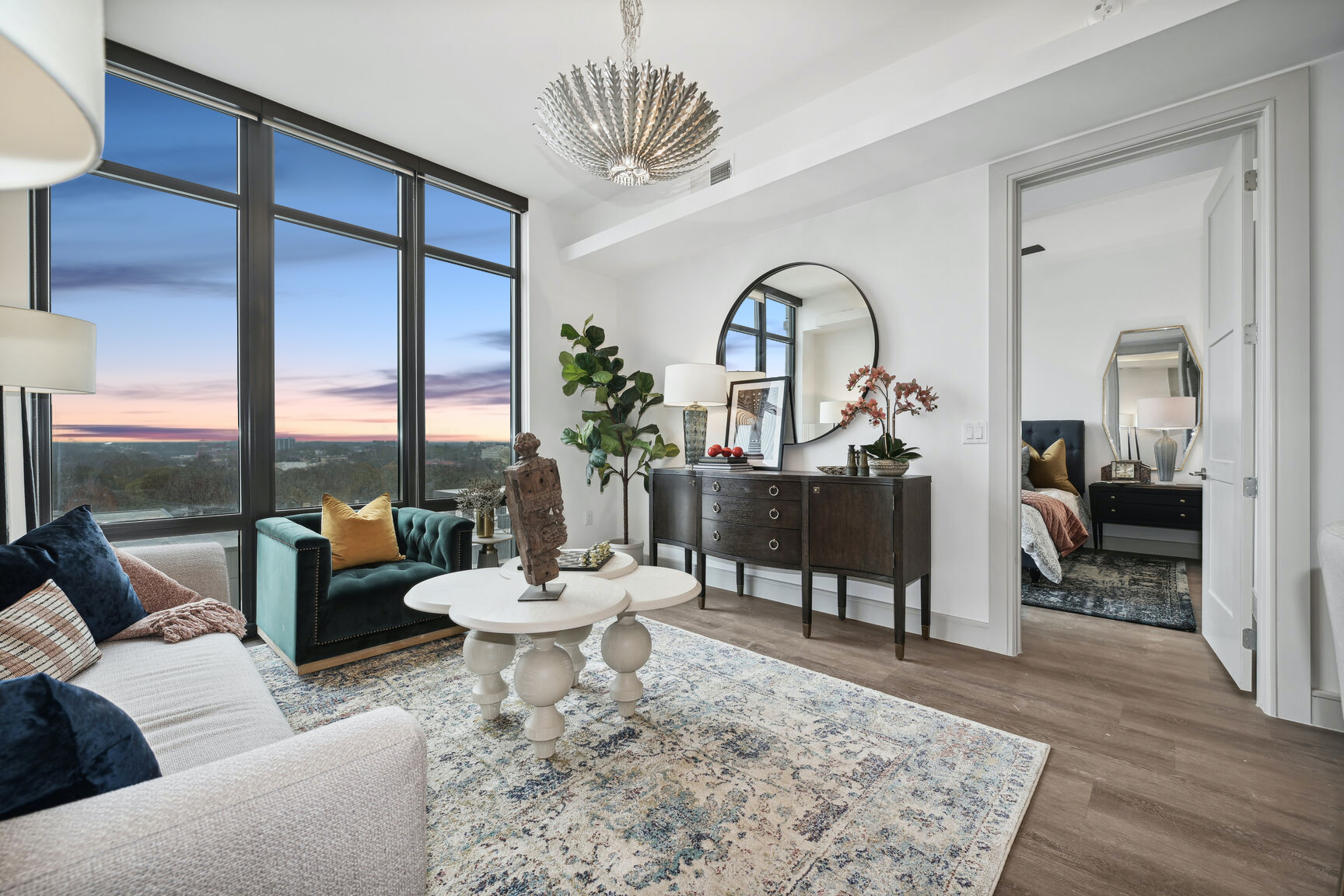 Living room with floor to ceiling windows overlooking Atlanta with a view of the bedroom at The Hadley